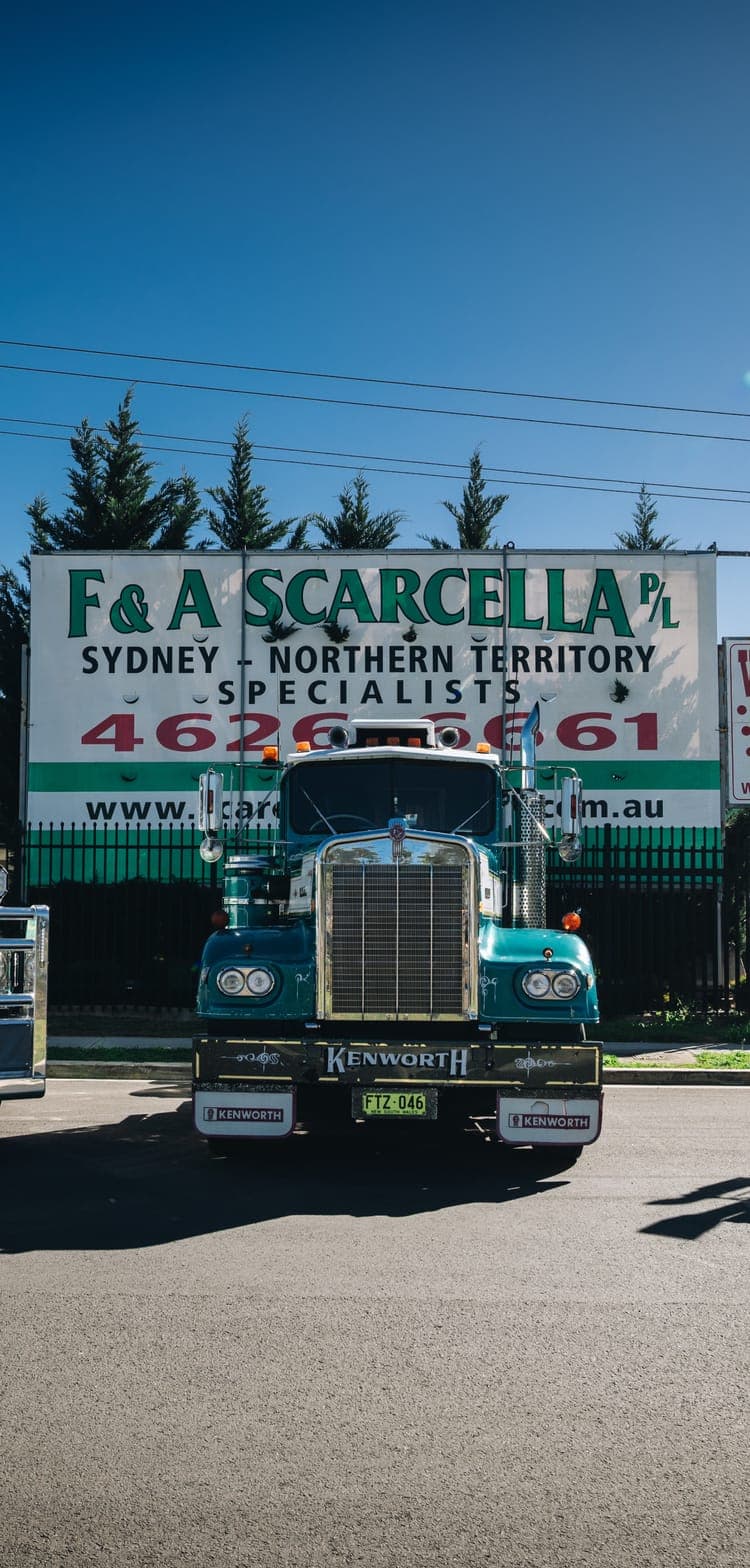 Scarcella Kenworth prime mover parked in front of the F & A Scarcella depot sign