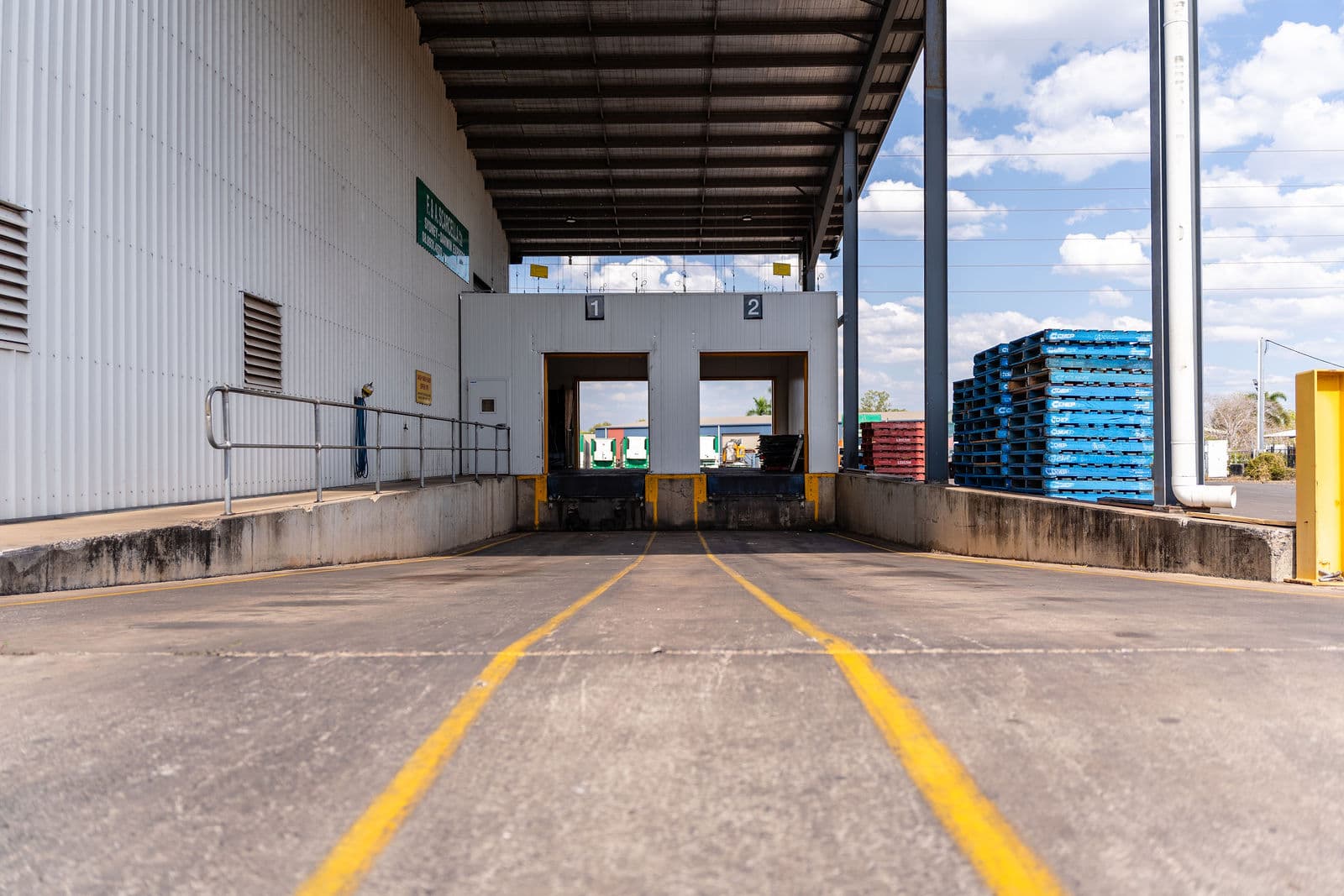 Loading dock bays one and two at the Darwin depot, pallets stacked alongside