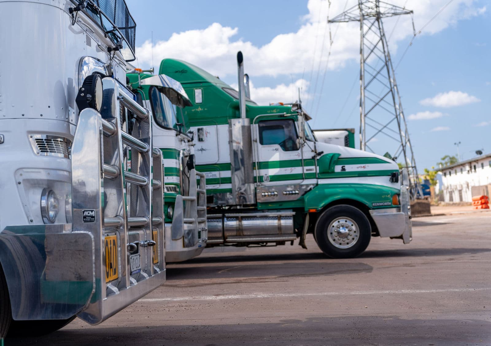 Green and white Scarcella prime movers parked in a row at the Darwin depot