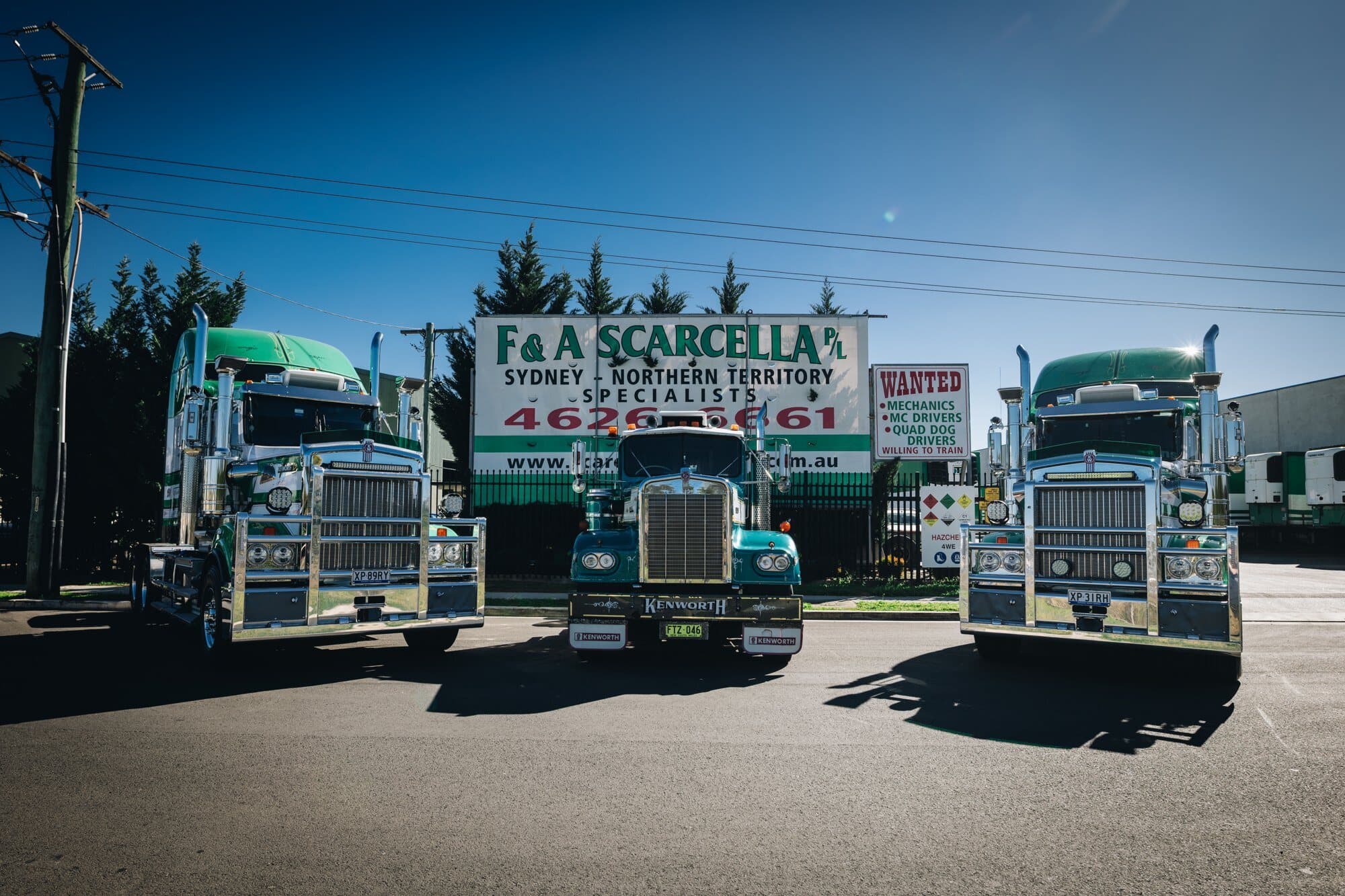 Three Kenworths outside the Campbelltown depot in front of the F&A Scarcella sign