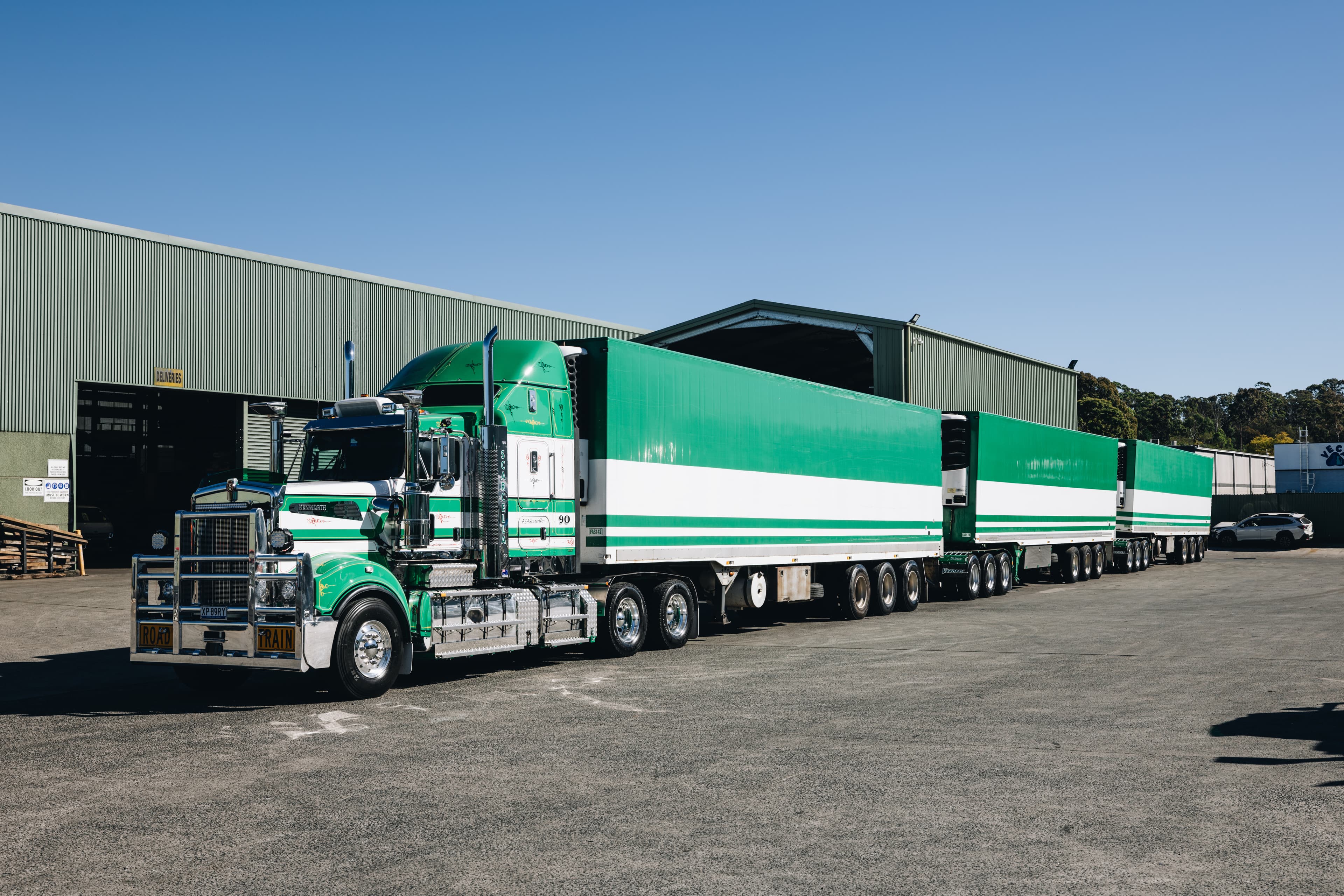 Scarcella road train — prime mover and three refrigerated trailers at the depot