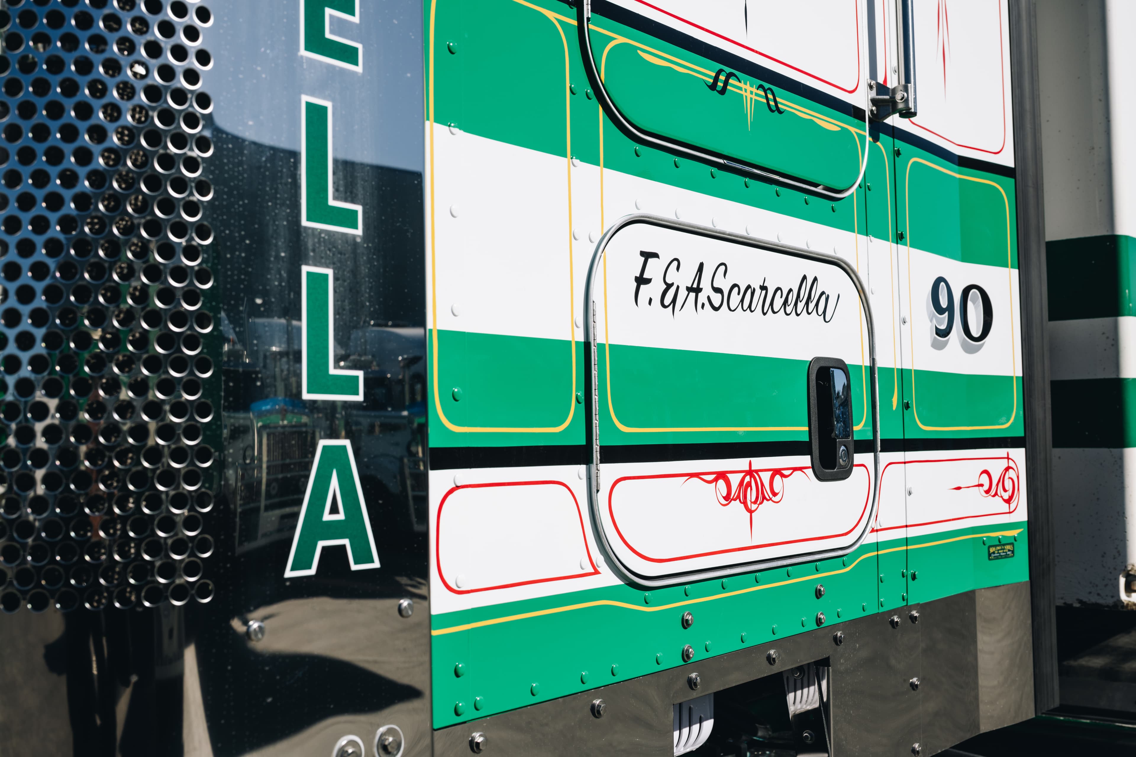 Hand-painted F. & A. Scarcella script on the door of truck 90