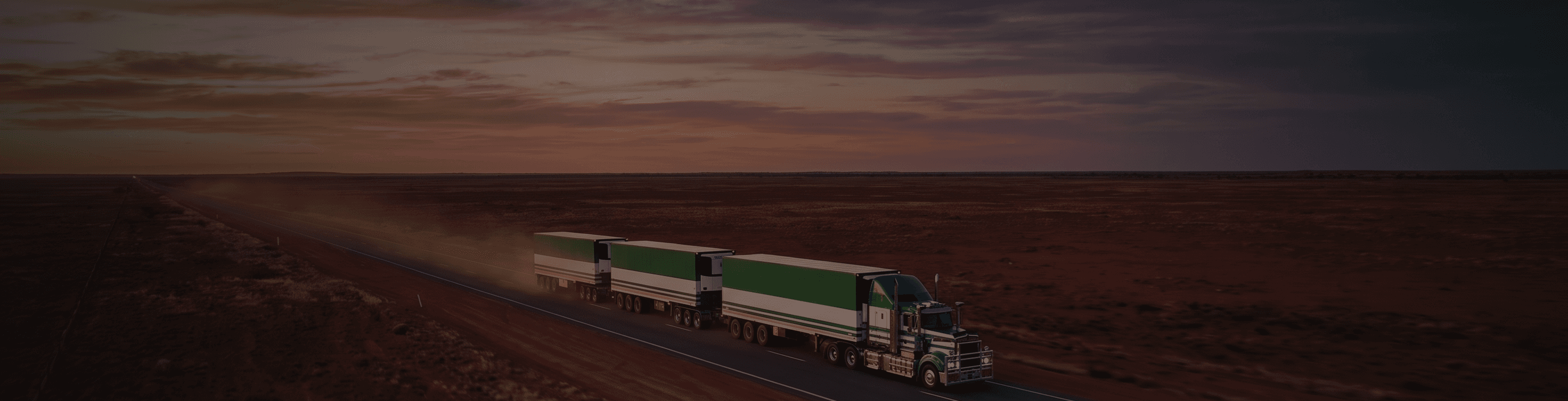 Scarcella road train on an outback highway at dusk